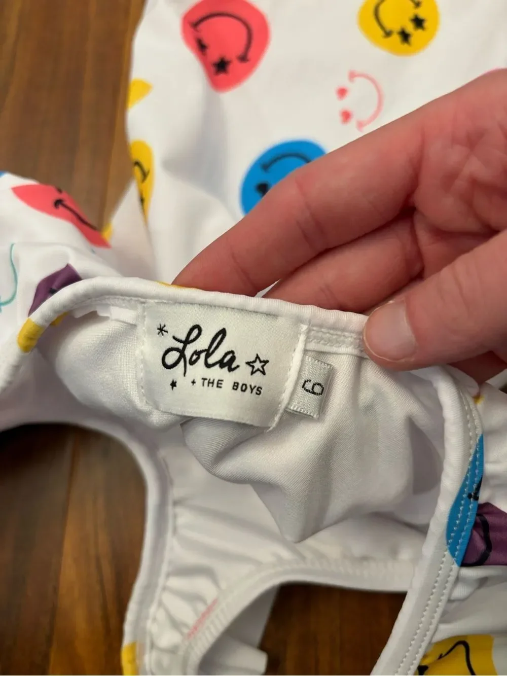 Lola + The Boys white smiley face one piece ruffle bathing suit